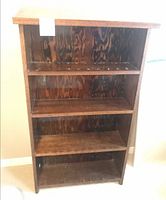 front view showing four shelves and wood grain