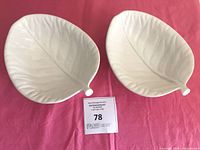 Both white ceramic leaf-shaped bowls top view