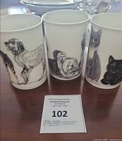 Front view showing three mugs and animal illustrations
