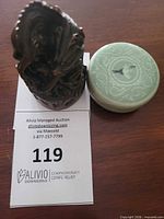 Figurine and lidded box side by side