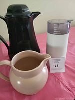 Overall view of all three items: carafe, pitcher, grinder