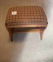 Top view showing plaid upholstered cushion and wood frame