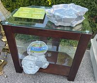 all five pans displayed on glass shelf unit