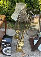 Two brass table lamps with different glass shades, boxed LED lamp at base