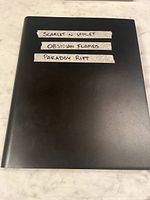 Closed black binder labelled with included sets