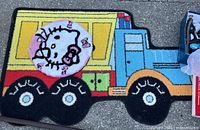 Truck-shaped rug showing full design and colors