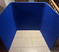 Top-down view of unfolded blue tri-fold display board