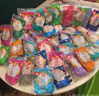 Tabletop view showing all 39 sealed Teenie Beanie Babies in various colored numbered bags