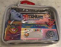 Front view of sealed Ty Beanie Babies Platinum Membership kit showing bear, cards, coin inside clear window