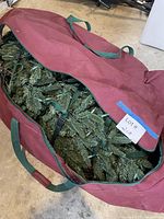 Canvas carry bag containing artificial tree sections