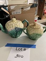 Teapot and covered bowl side by side on table