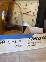 Overview of lot showing clock, cloche and basket