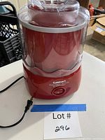 Front view of red Cuisinart frozen dessert maker showing brand label and control switch