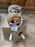 Overall lot view with two buckets, plaster hawks and contents