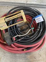 Coiled red and black hoses with both sprinklers on top