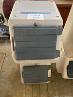 Front view of stacked plastic bins with gray doors