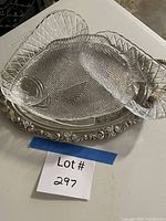 All four serving pieces grouped: two glass celery dishes, plastic fish platter, metal tray