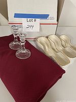 Full lot showing tablecloth, two candlesticks, three ceramic rests