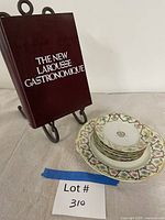 Overall lot showing cookbook on stand with stack of plates