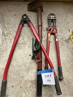 Group of five hand tools laid on concrete floor