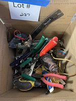 Top view of box showing assortment of pliers, shears, snips and tape measure