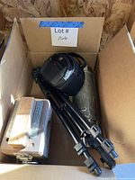 Overall lot view inside box showing tripod, camera bag, Stanley thermos and wooden mold