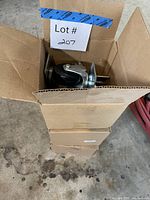 Stack of three caster boxes, top box open showing casters