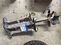 Collapsed stilt showing full frame, springs, straps, foot plate
