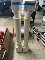 Full view of both white wooden cabinet columns standing upright