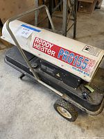 Full left side view showing branding, wheels, handle, and overall condition