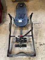 Full view of Teeter inversion chair on concrete floor