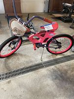 Left side view of pink and purple girls bicycle with basket