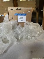 Box and bubble-wrapped clear glasses visible