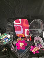 Group shot of all acrylic trays, patterned tray, salad bowl halves, cutlery, skewers and dip bowls