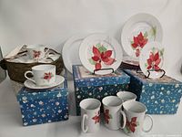Group view of plates, teacups, mugs on boxes