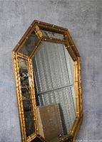 Front view showing entire octagonal mirror on wall