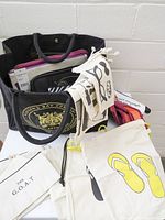 Group shot of tote loaded with pouches and drawstring bags