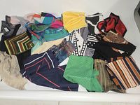 Overview of all 20 scarves laid out showing varied colors and patterns