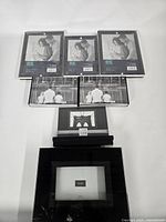 Seven black photo frames arranged by size