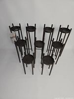 Full set of 10 dark bronze metal candle holders front view