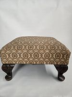 Full view of footstool showing upholstery and all legs