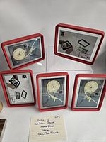 Front view of five red Umbra 4x6 frames showing inserts