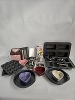 Group shot showing all bakeware, ramekins, measuring sets, cutters, utensil holder, box