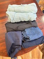 Stack of six folded blue and black linen pieces