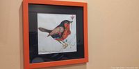 Front view of framed original robin painting in orange frame