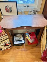 Full view of wooden console table showing curved front and lower structure
