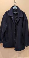 Front view of navy Dockers wool coat on hanger