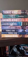 Stack of eight Thomas King DreadfulWater novels showing spines and titles