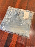 Jeans folded in original plastic packaging