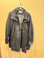 Front view of Tower by London Fog jacket hanging open showing plaid lining